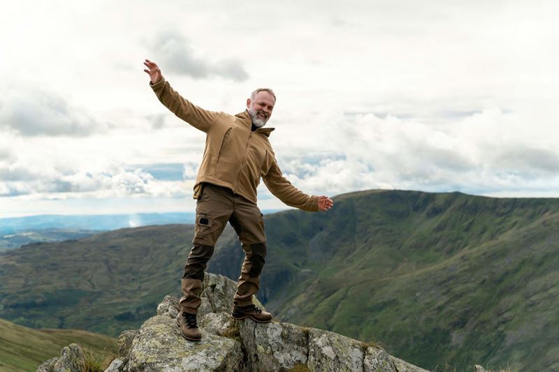 A hiker balancing on a rock