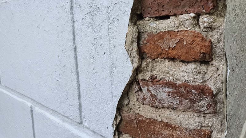 A wall behind a broken tiles