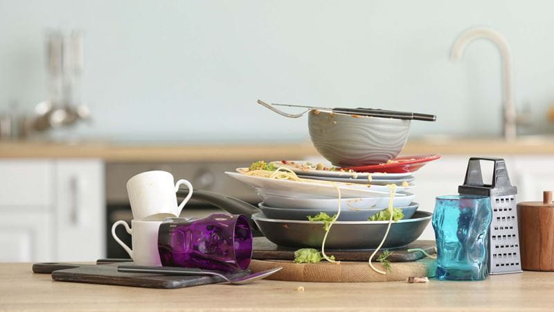 Unwashed crockery and cups on a kitchen counter