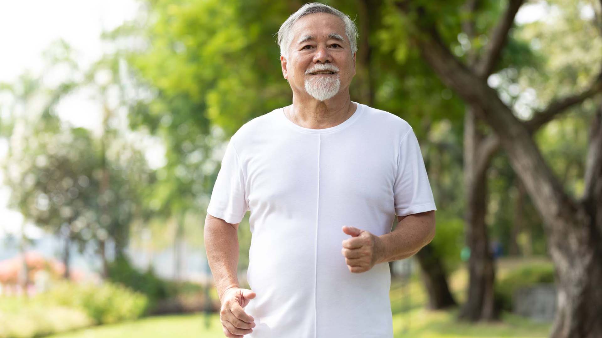 senior man running and exercising in the park