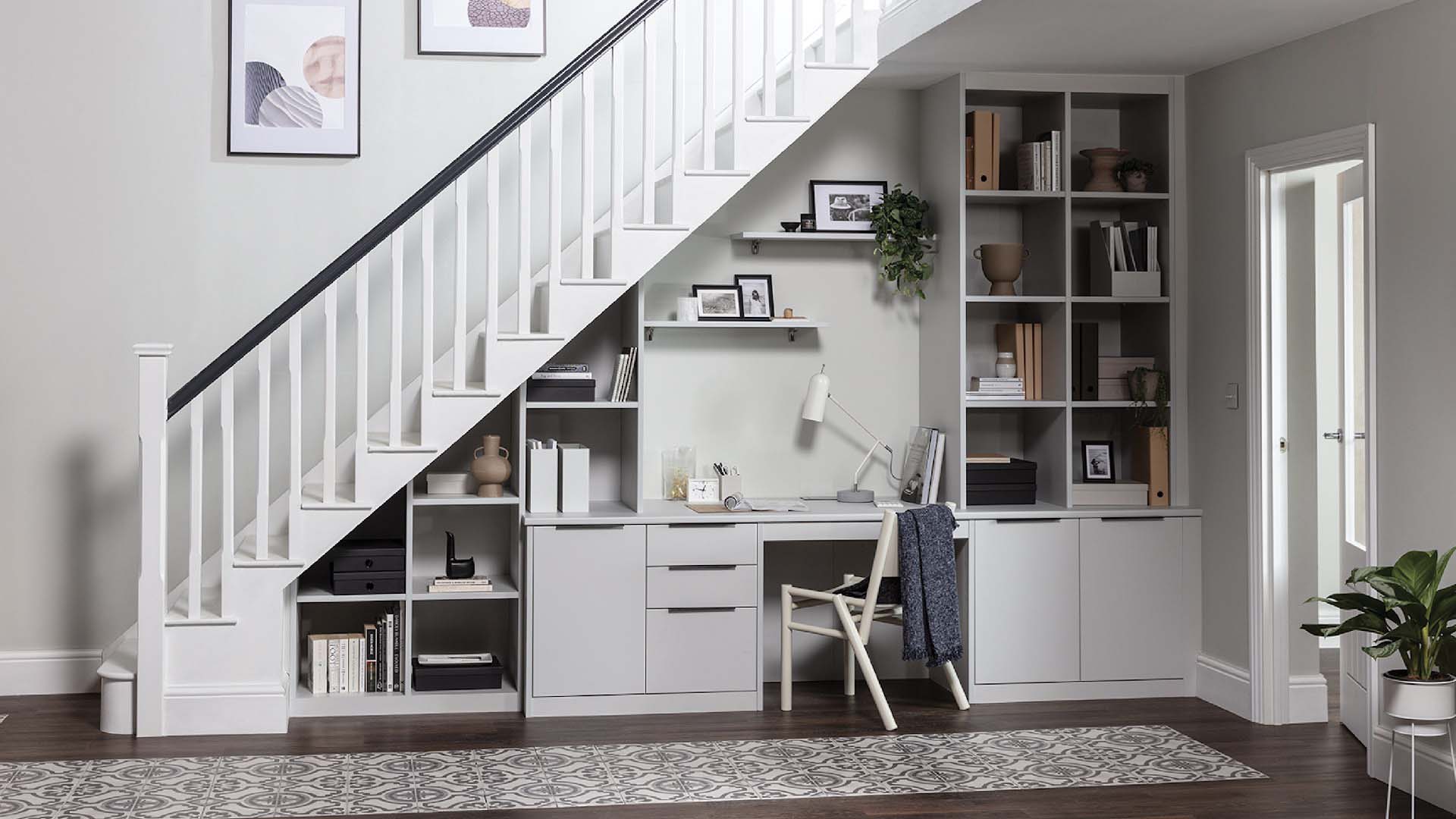 office with built in cupboards under the stairs