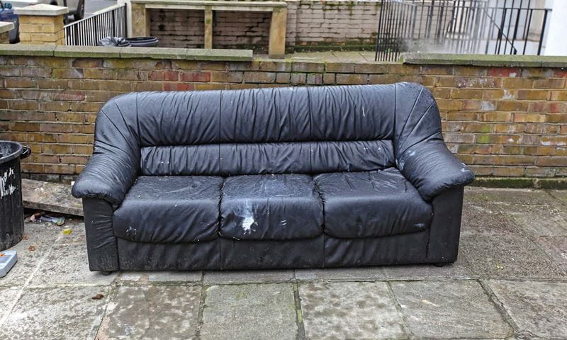 An old blue sofa on the street