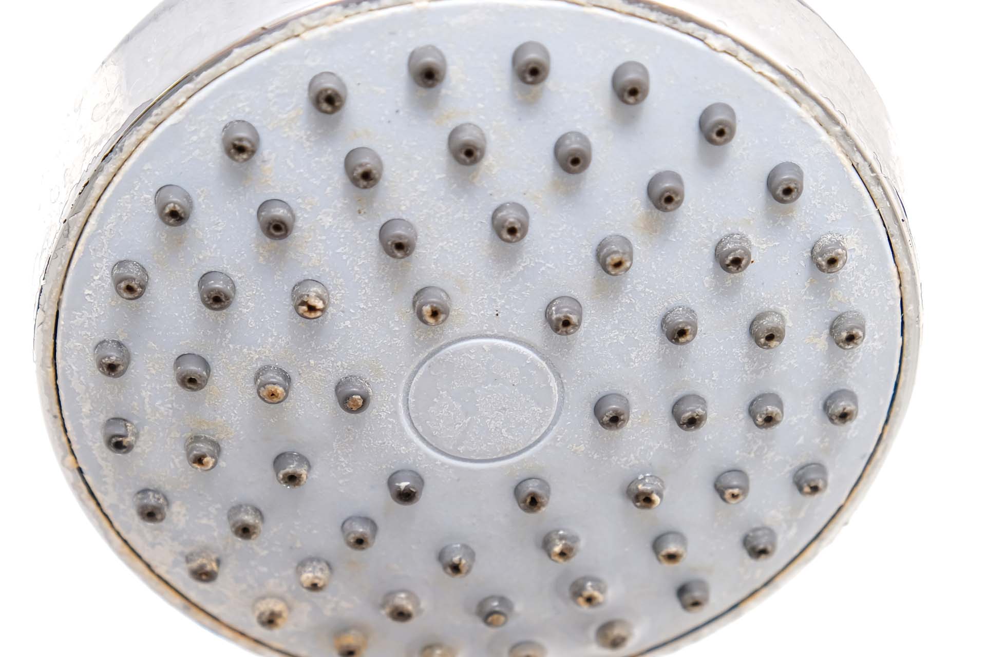 Limescale build up on a shower head over time