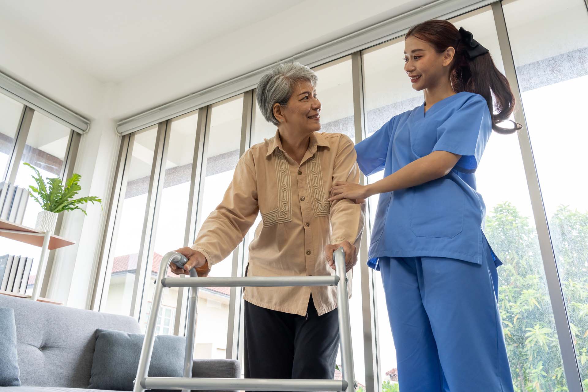 Nurse helping a mature patient walk around