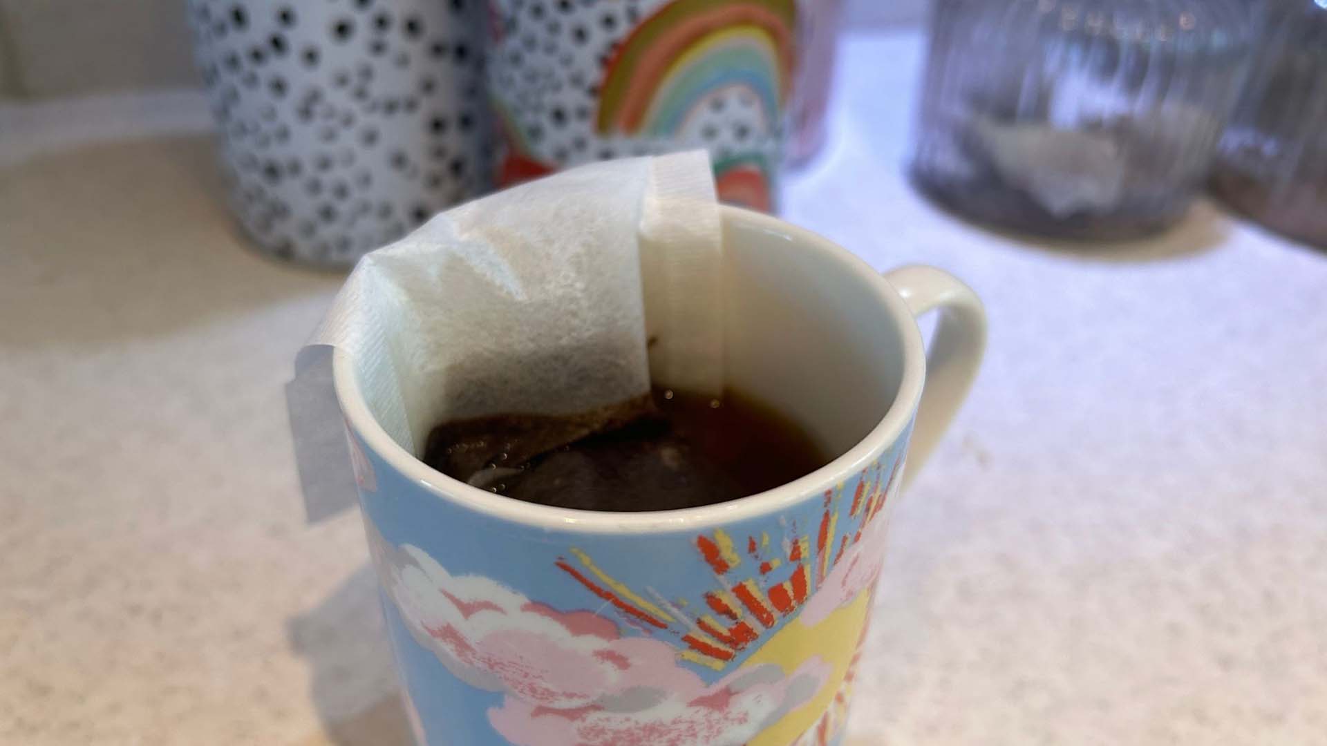A coffee mug with a coffee bag inside