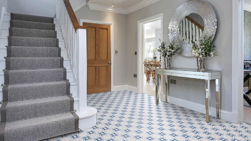 A grey entranceway with a staircase on the left side