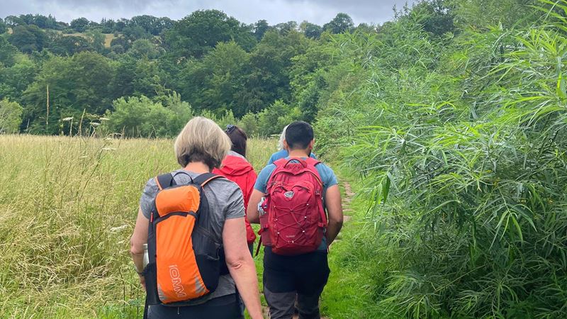 A group of people walking through the countryside