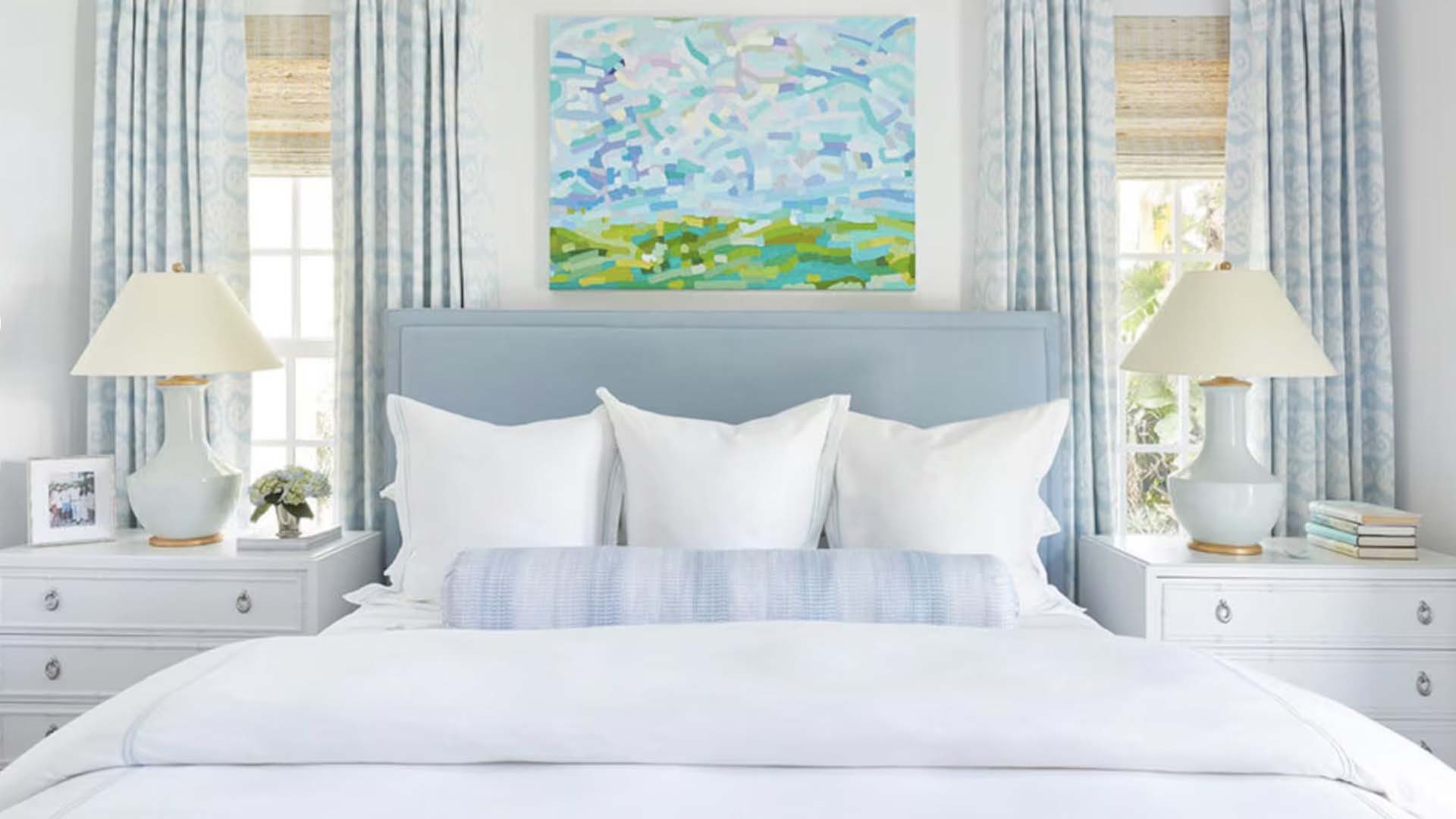 Bed with pillow in between the windows