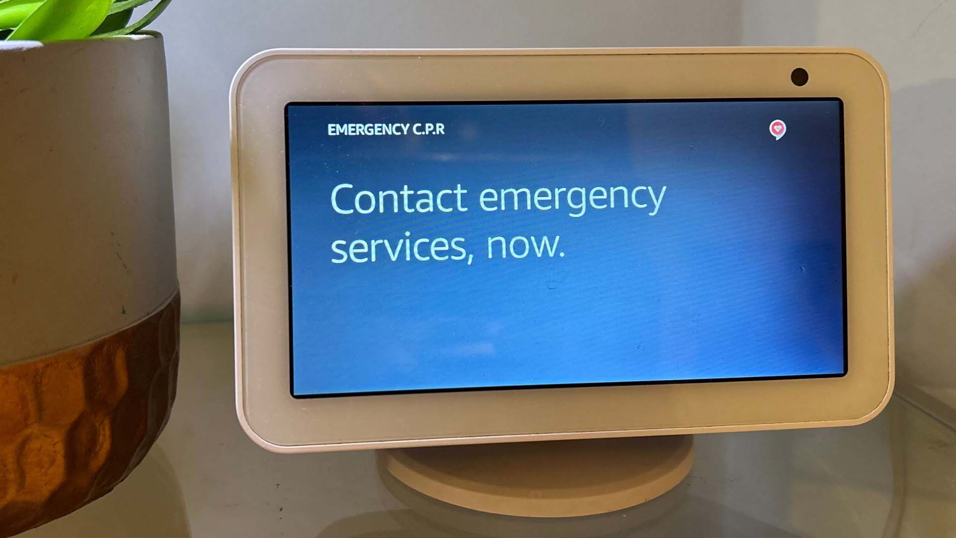 Close-up of a screen showing the message 'contact emergency services now'