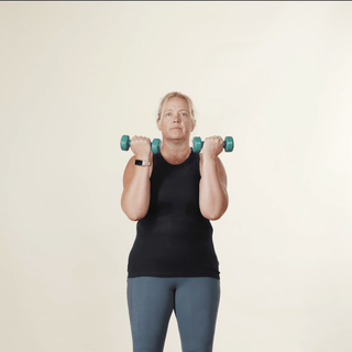 woman showing how to do an Arnie overhead
