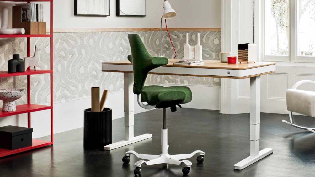 A green desk chair at a white desk