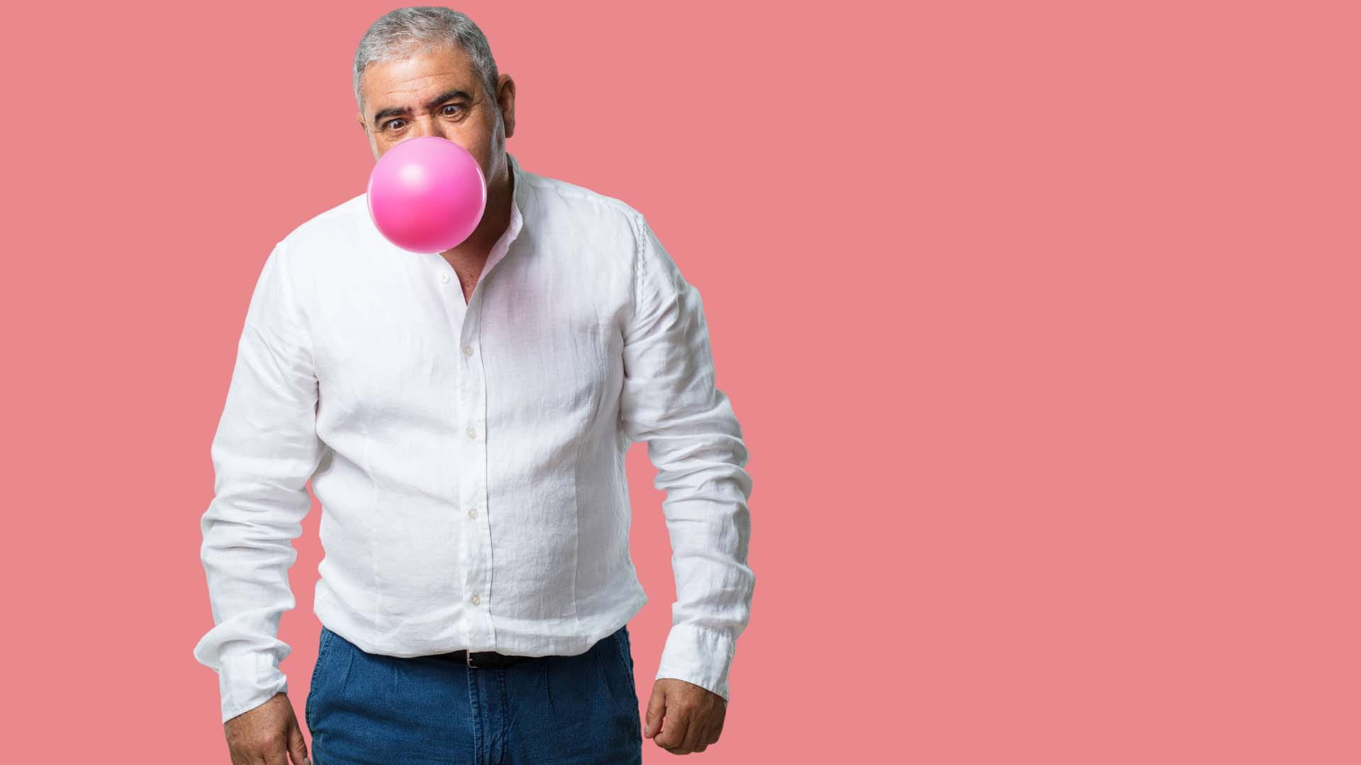 A man with an inflated balloon in his mouth