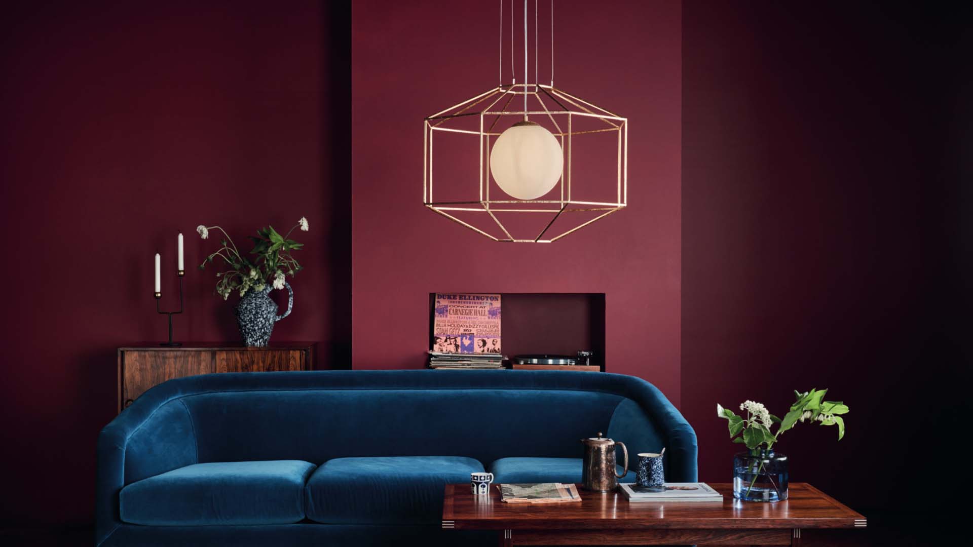 Red living room with gold lamp shade