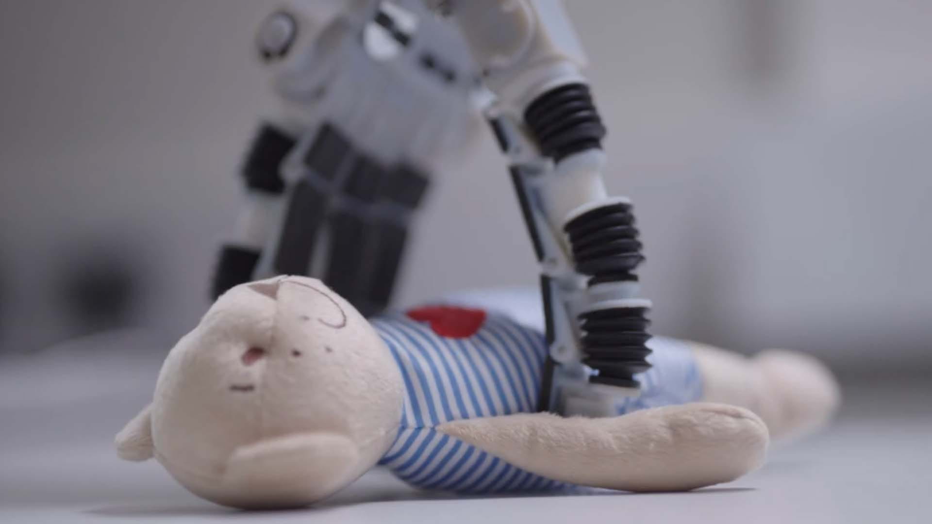 a robot picking a toy off the floor