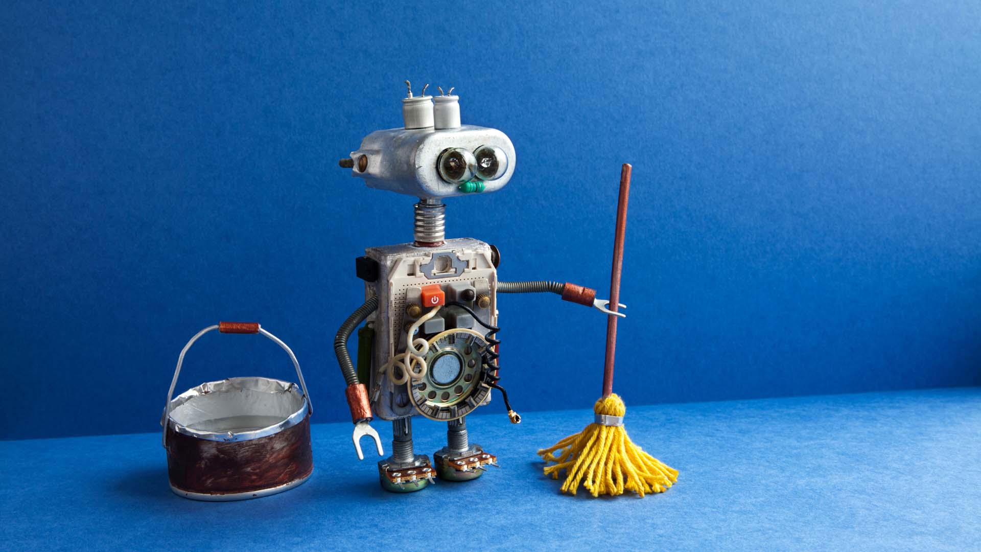 little robot with a mop and bucket