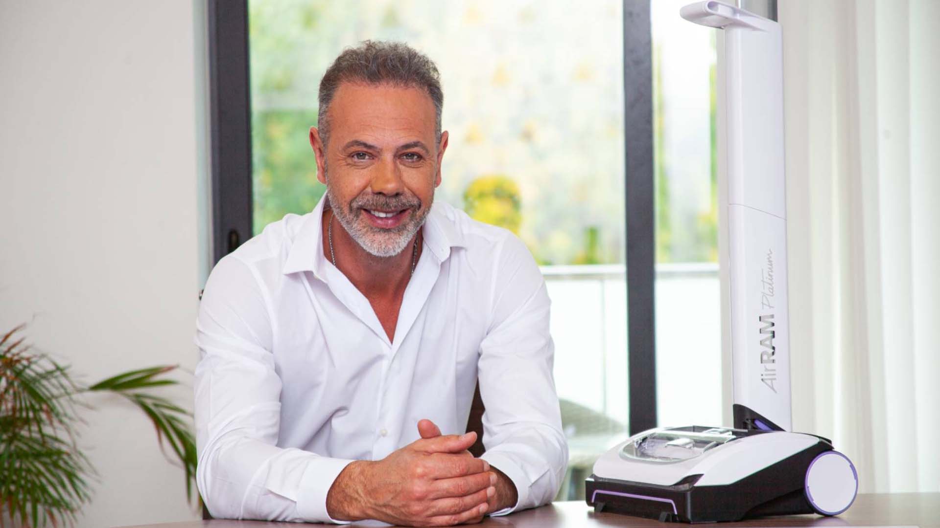 Nick Grey sitting next to one of his inventions