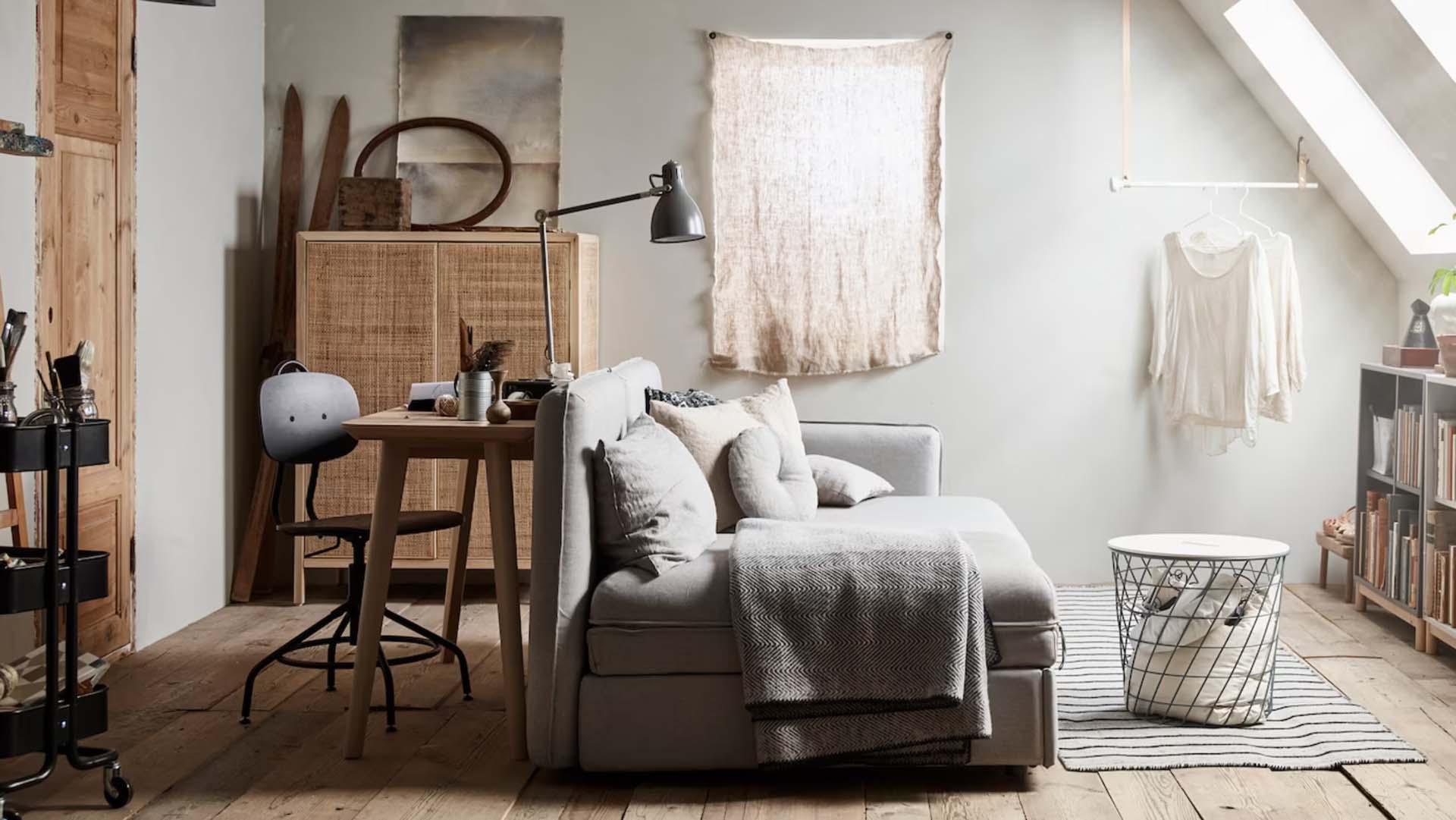 A sofa bed being used to divide a room