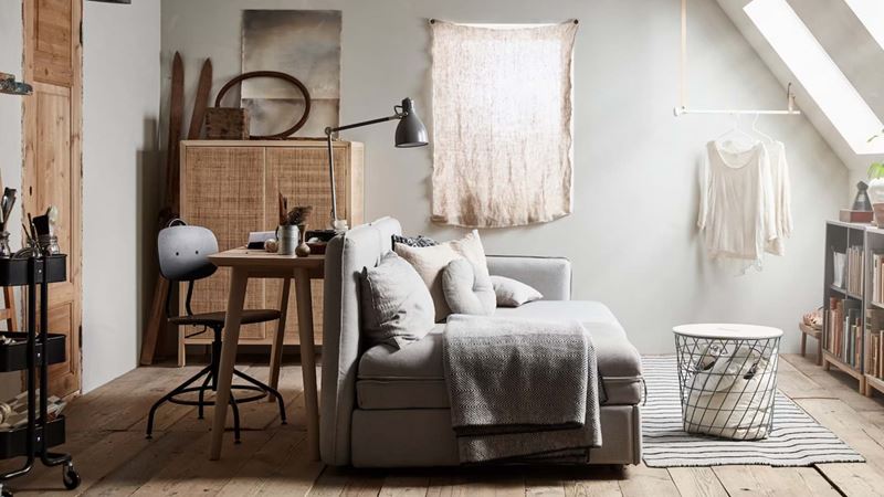 A sofa bed being used to divide a room