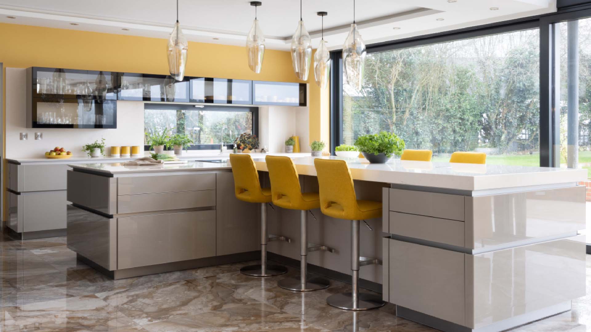 a bright kitchen with cream units and bright yellow walls