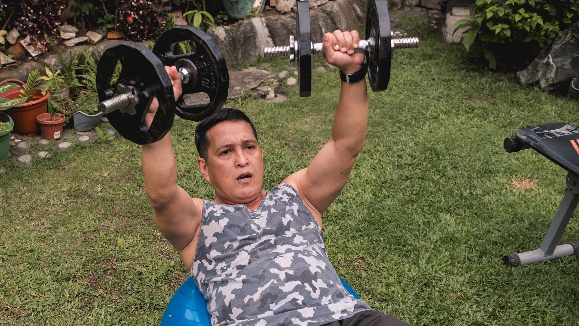 man doing a chest press on a swiss ball