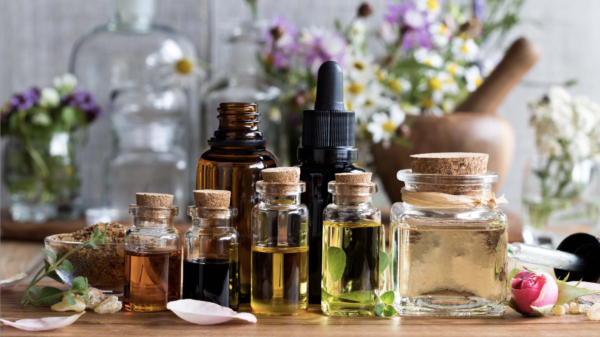 An assortment of jars filled with various natural oils