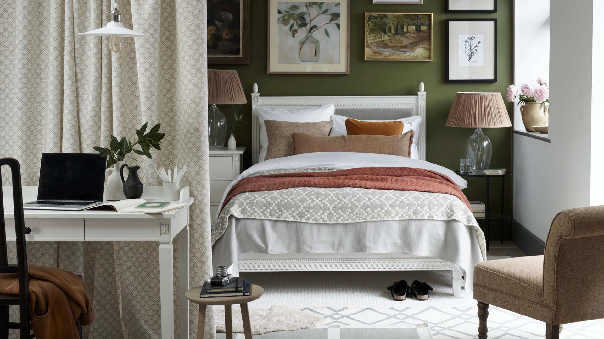 a curtain divider in a spare room with office desk