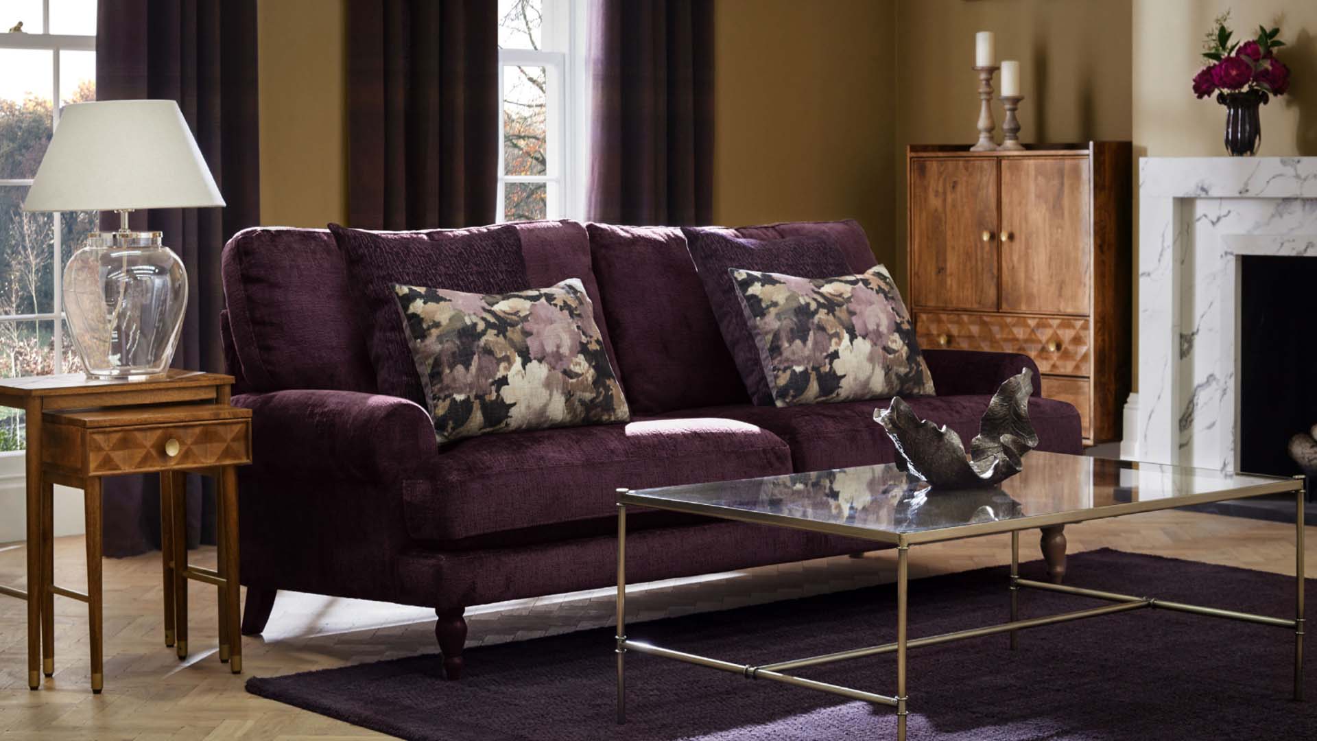 A room with yellow walls and a purple sofa