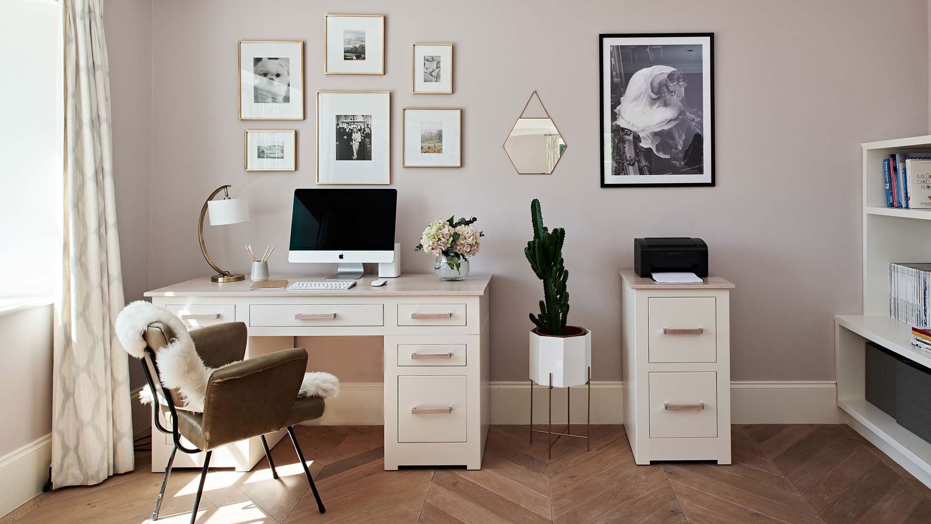 white modern desk against a gallery wall