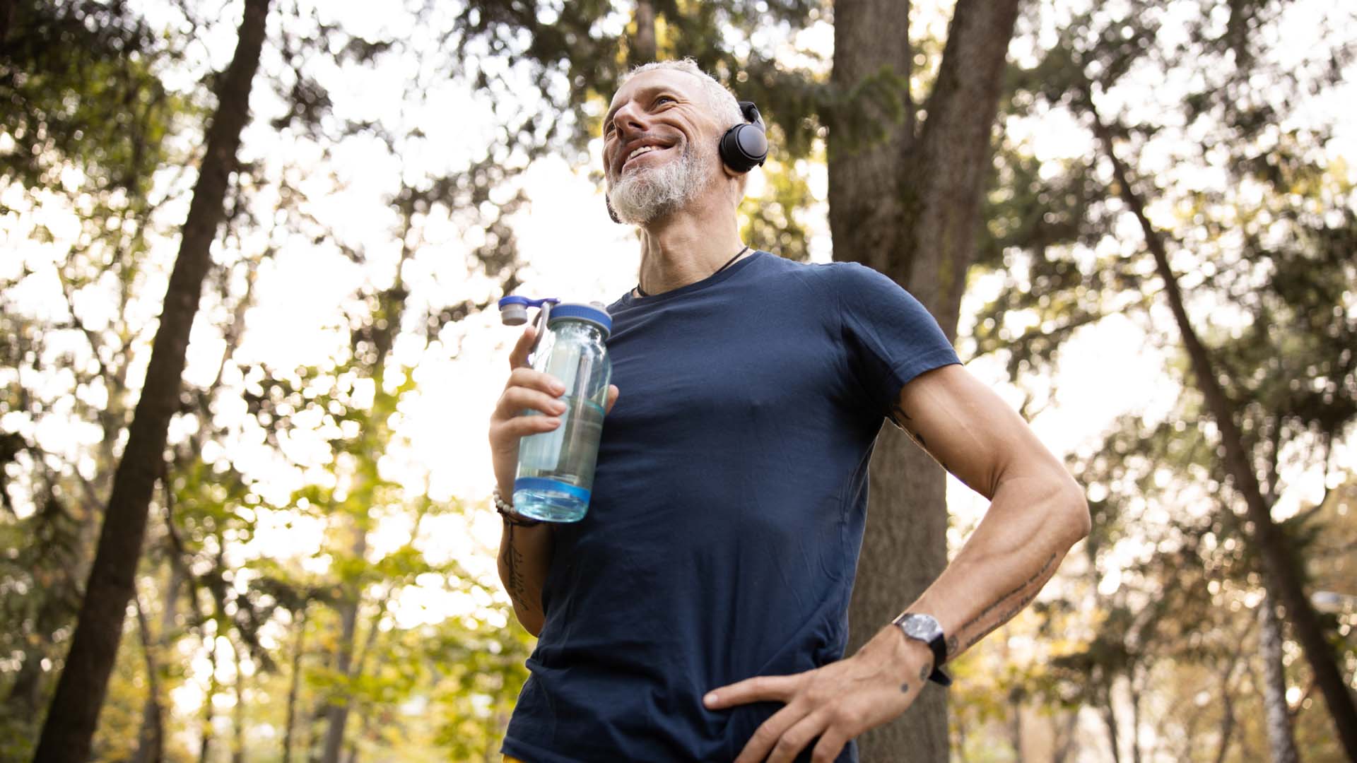 Older man with water bottle while running