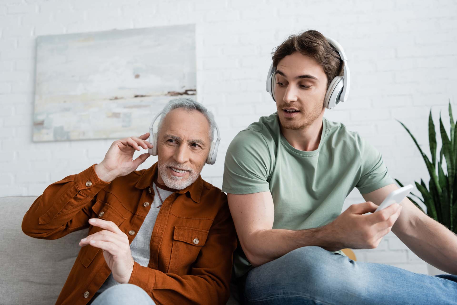 Men from different generations listening to music