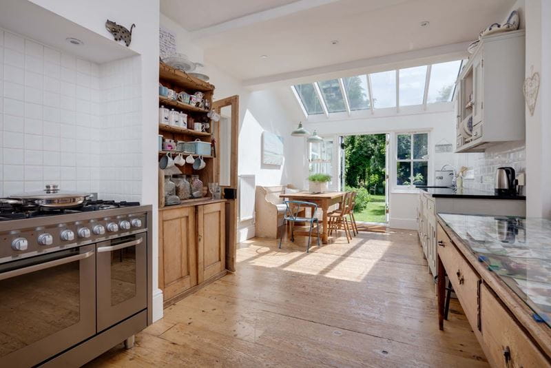 Light walls and cabinetry open up this small kitchen conservatory
