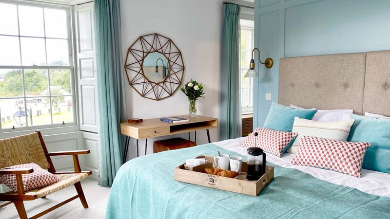 a slimline desk between two windows