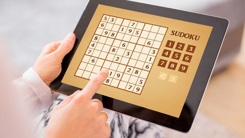 person playing sudoku on their ipad