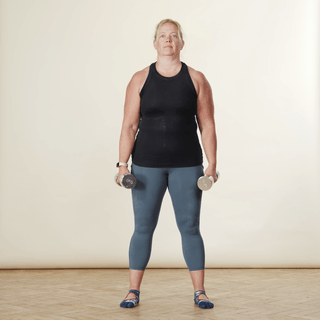 demonstrating how to do a weighted squat