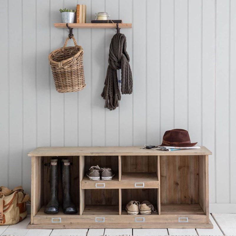 A shoe bench with hooks above
