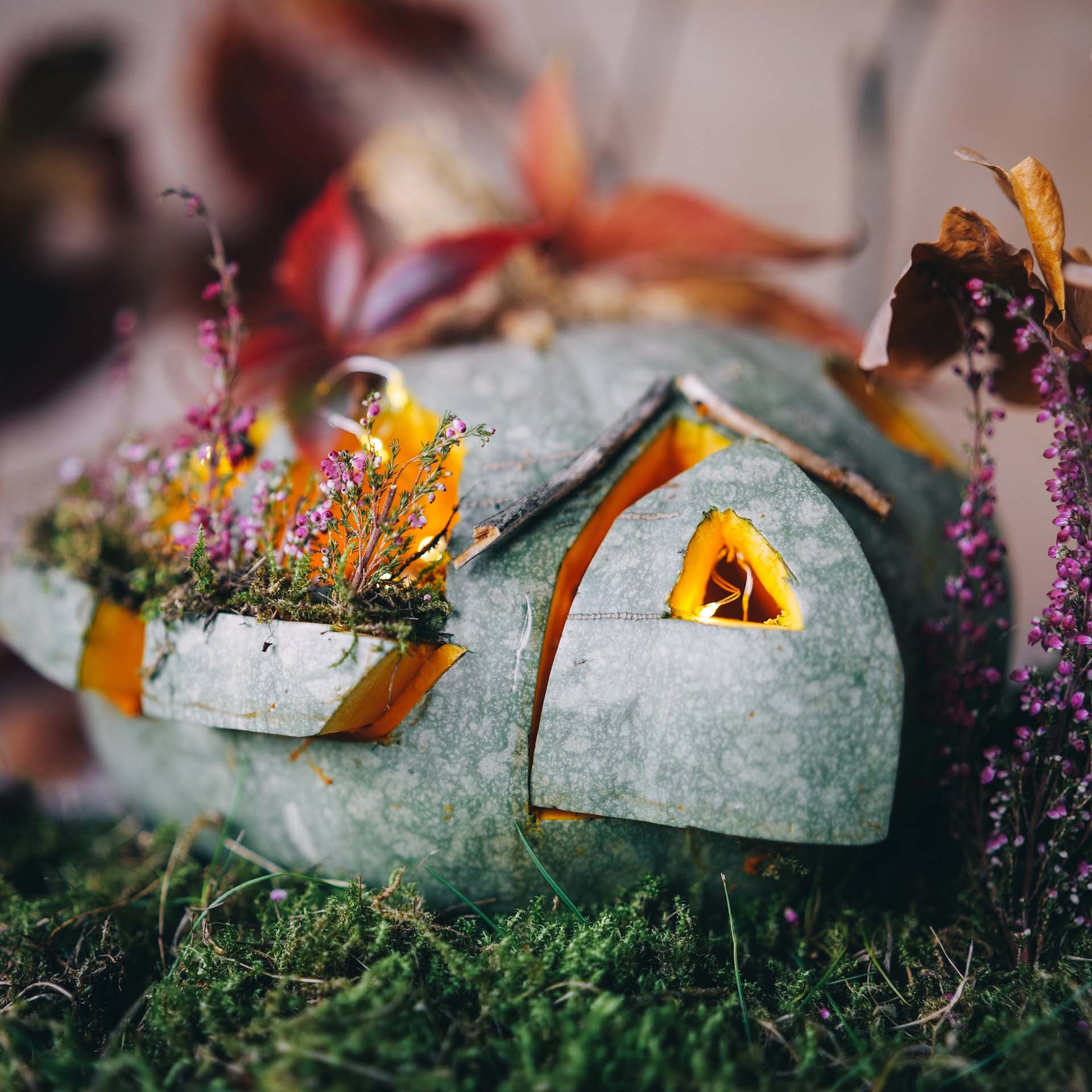 a pumpkin carved to look like a cottage