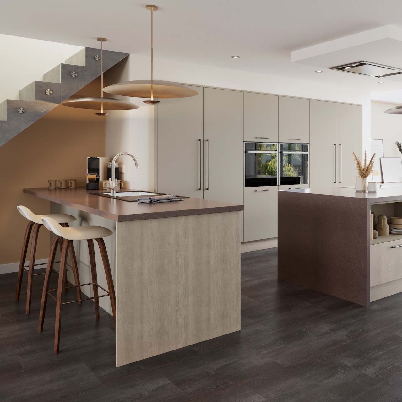 a modern kitchen with breakfast bar beneath free standing stairs