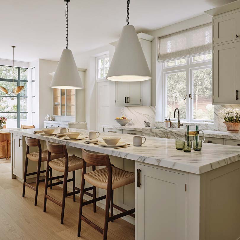 A long breakfast bar with three stools