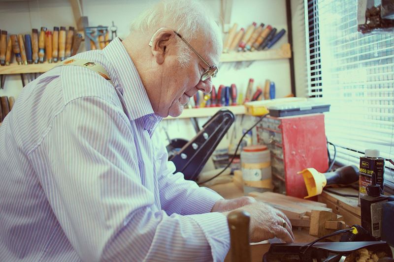 An older man working in his shed