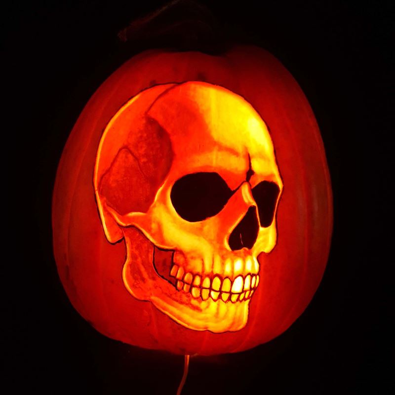 A skull image carved into a pumpkin