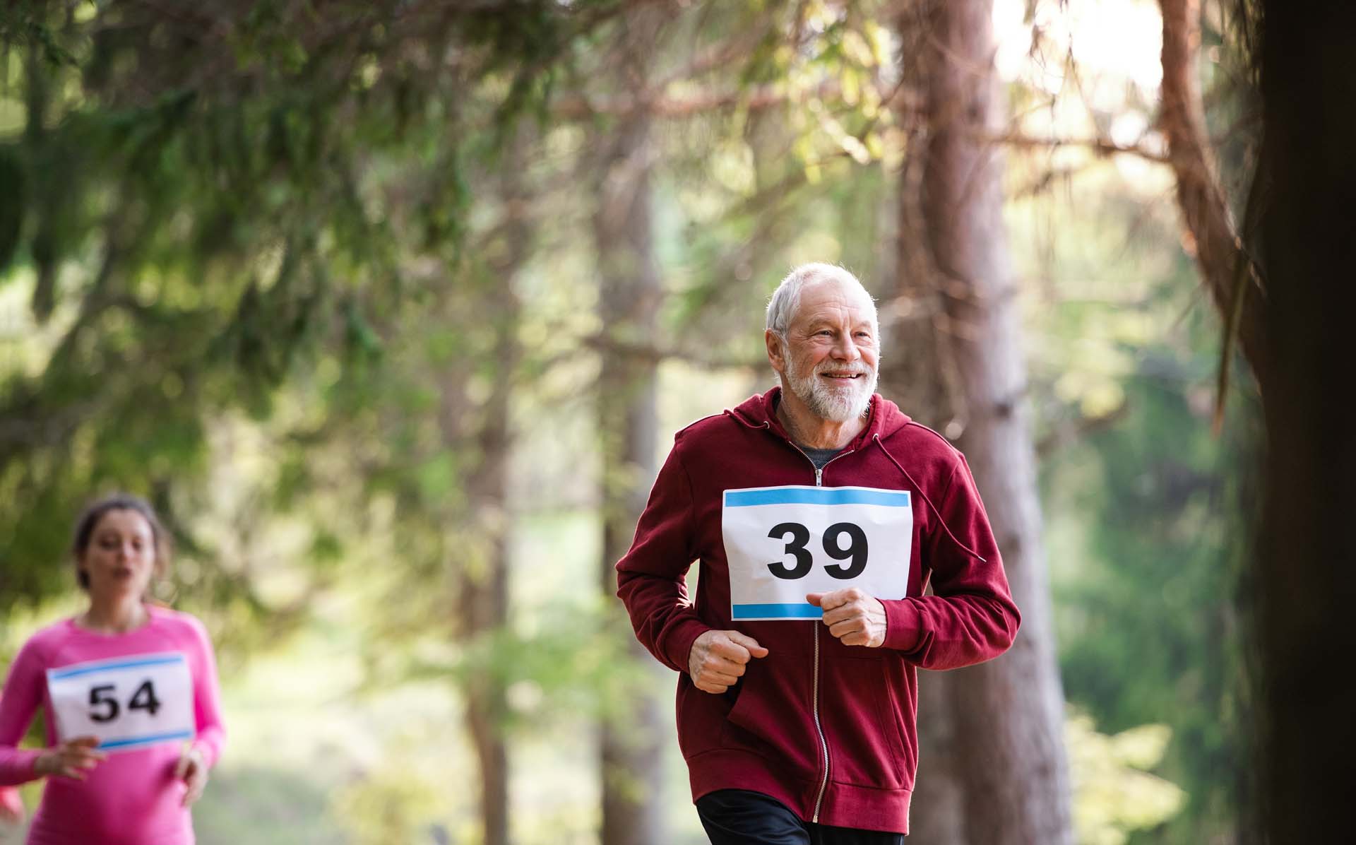 An older man running in the forest