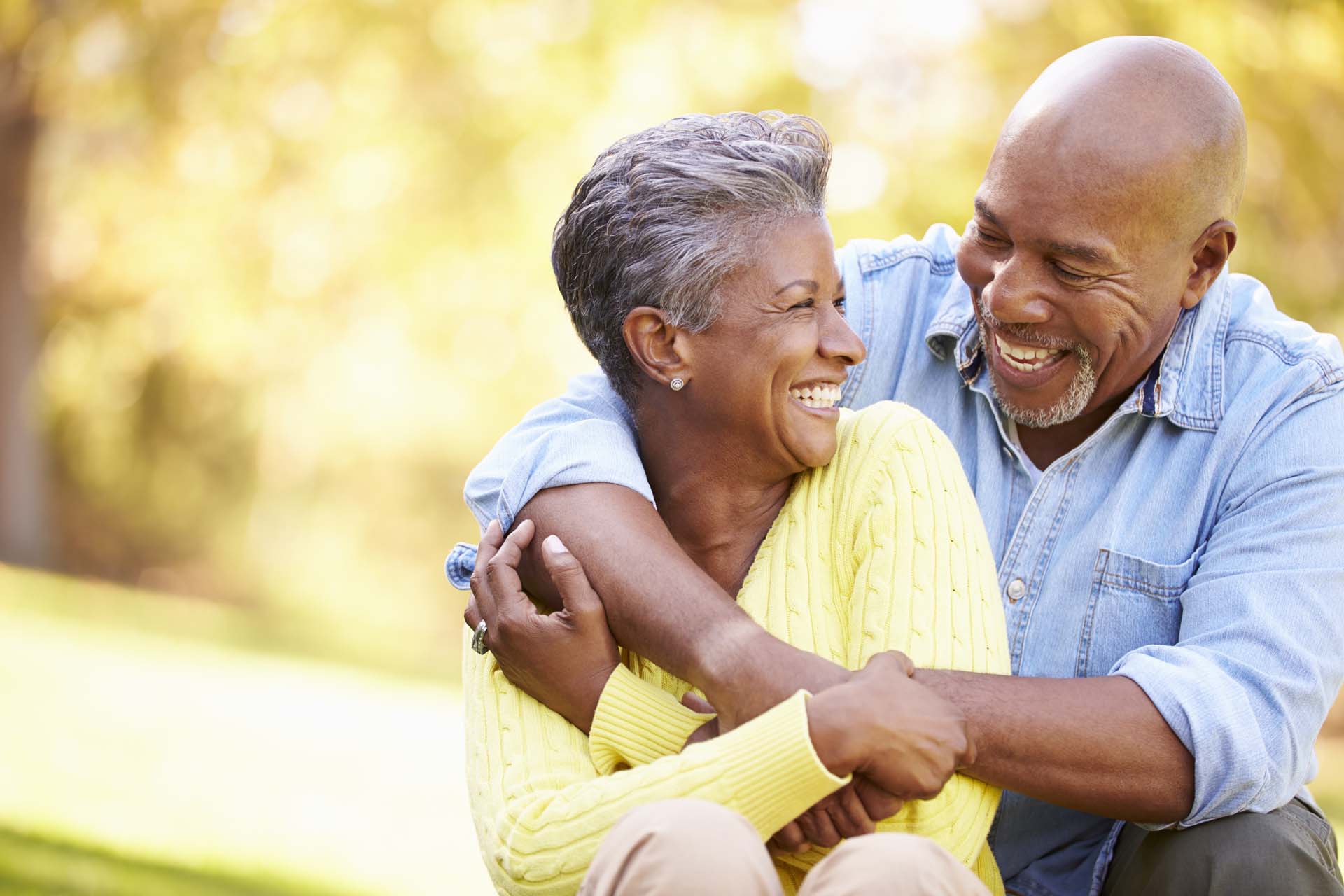 An older couple smiling and hugging