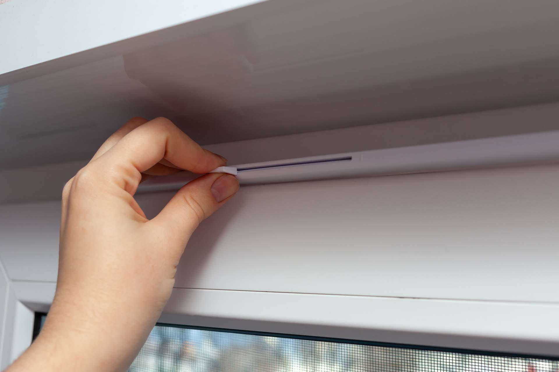 A hand checking the air vents