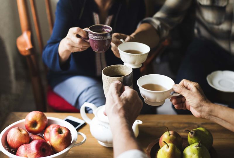A group of people having cups of tea