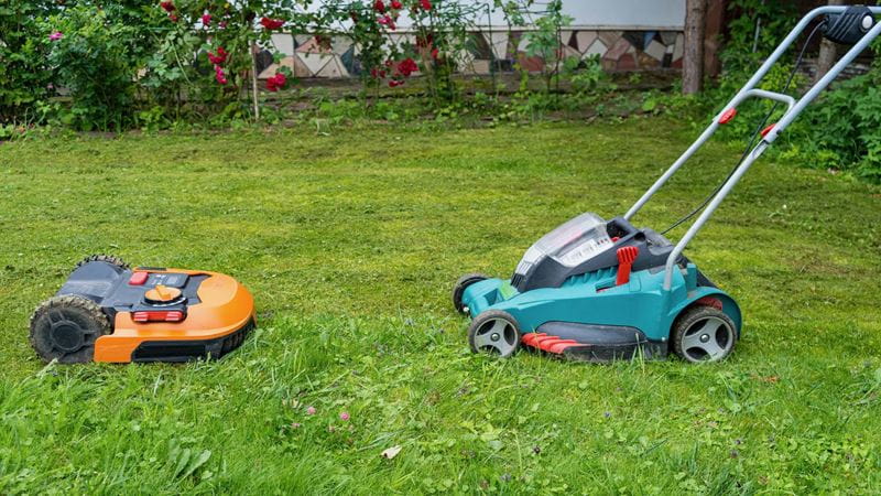 Two types of battery powered and cordless machinery in a grass area