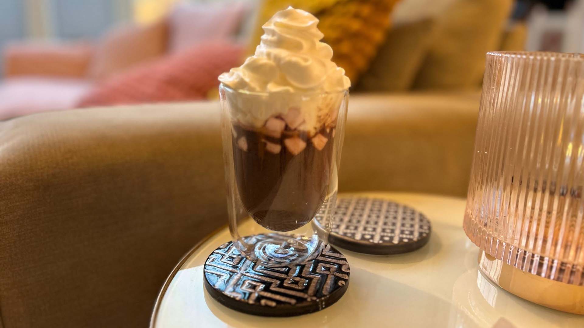 glass of hot chocolate with cream and marshmallows