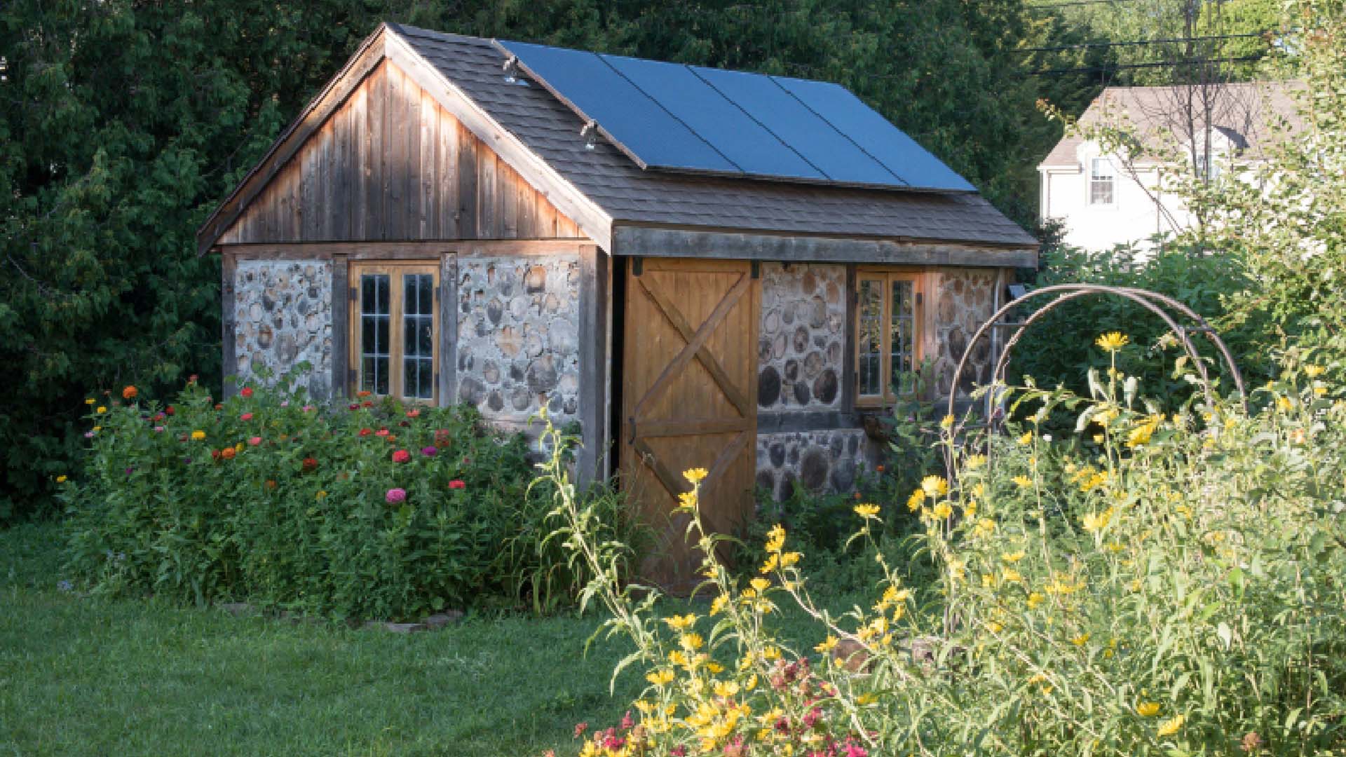 shed with four solar panels on the roof