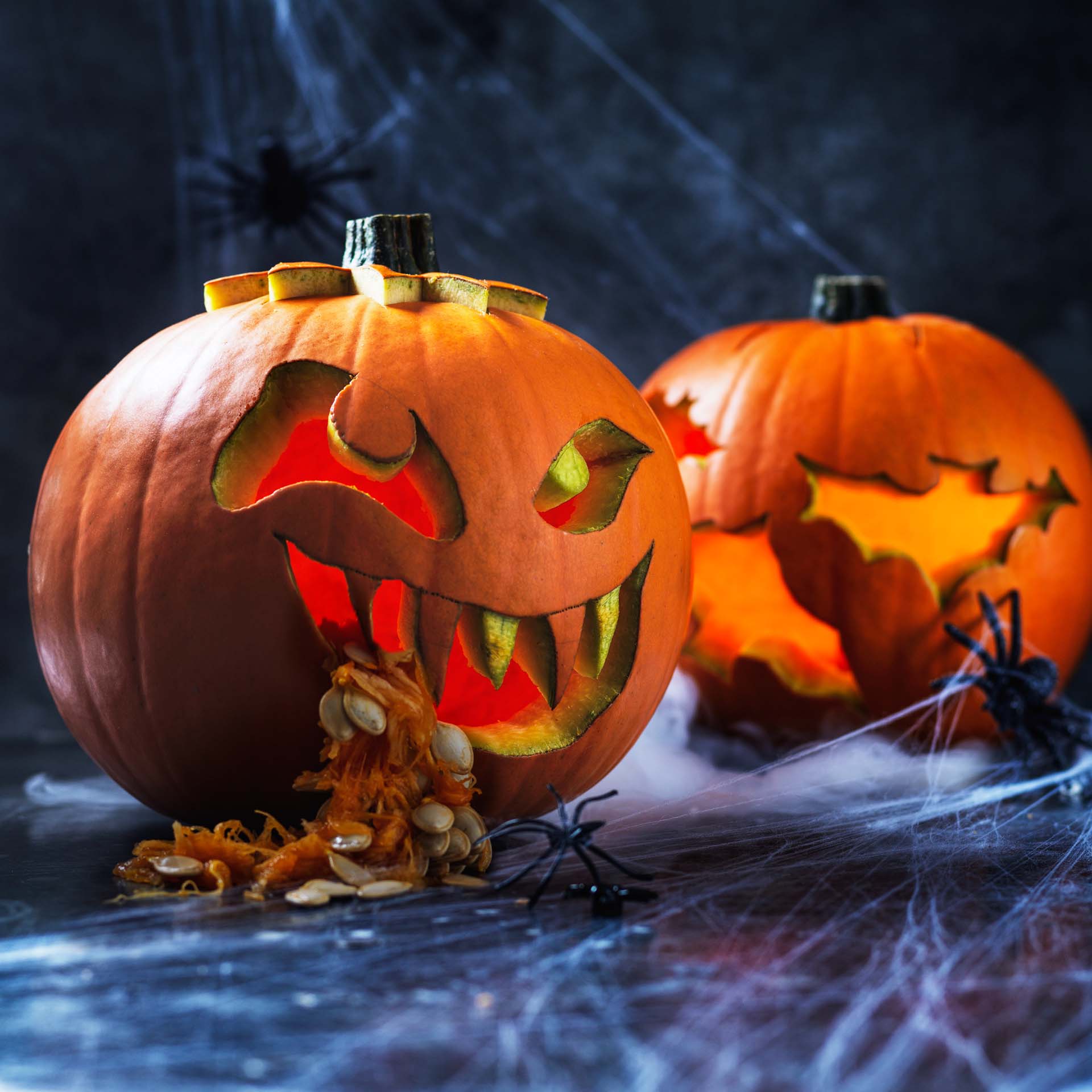 two spookily carved pumpkins