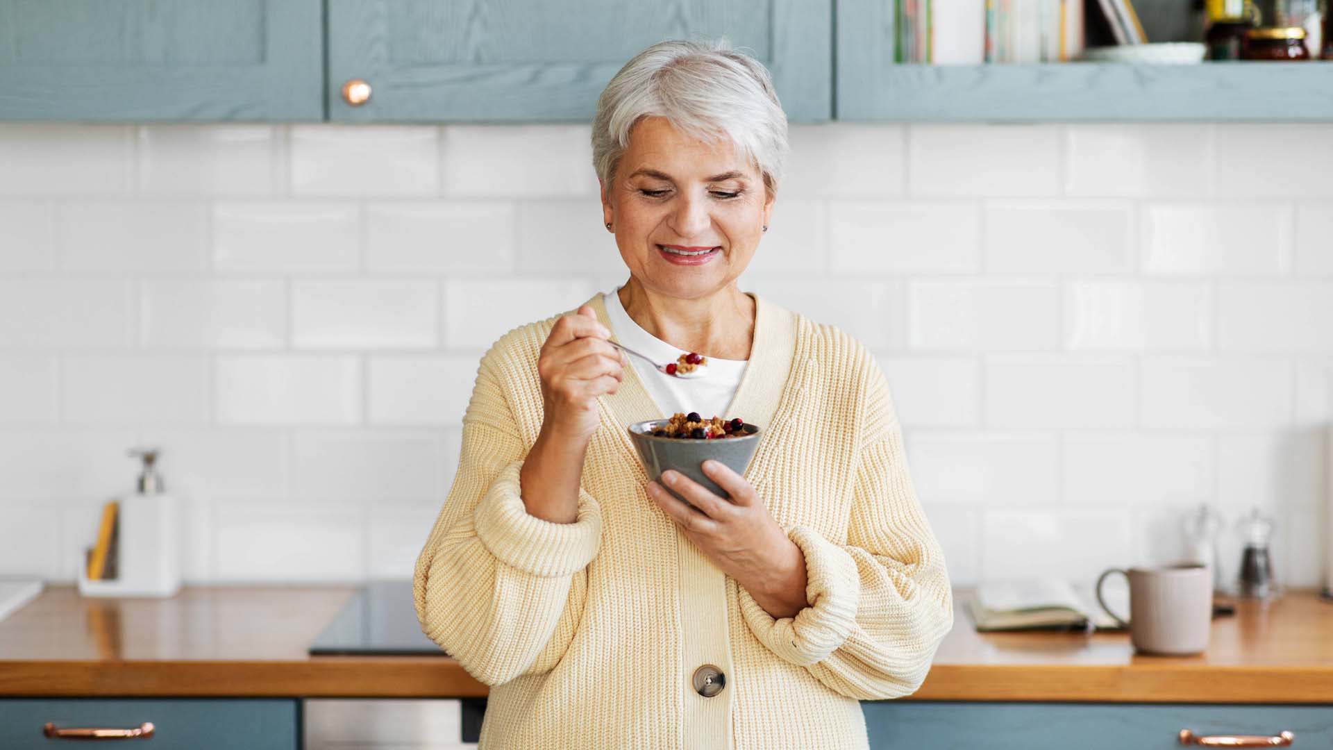 woman eating a bowl of grains