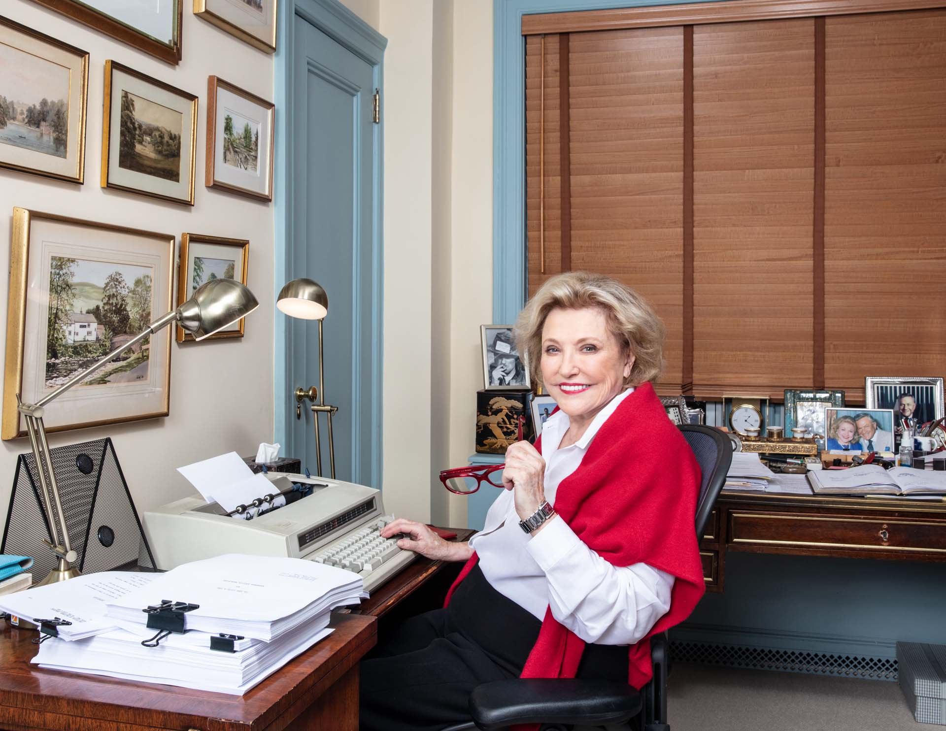 Barbara Taylor Bradford sat at her desk and typewriter